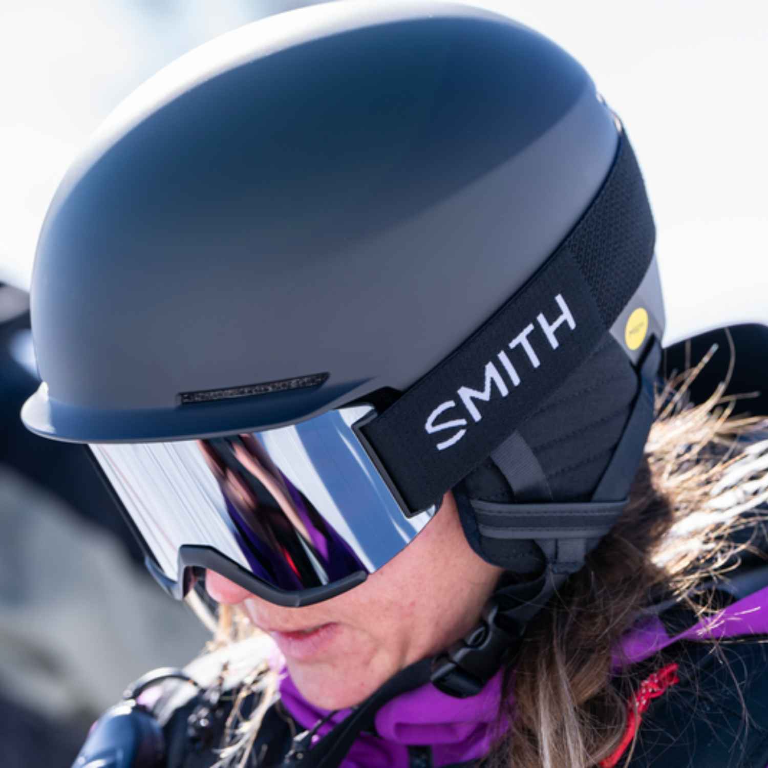 Women wearing ski helmet and ski goggles in the snow.