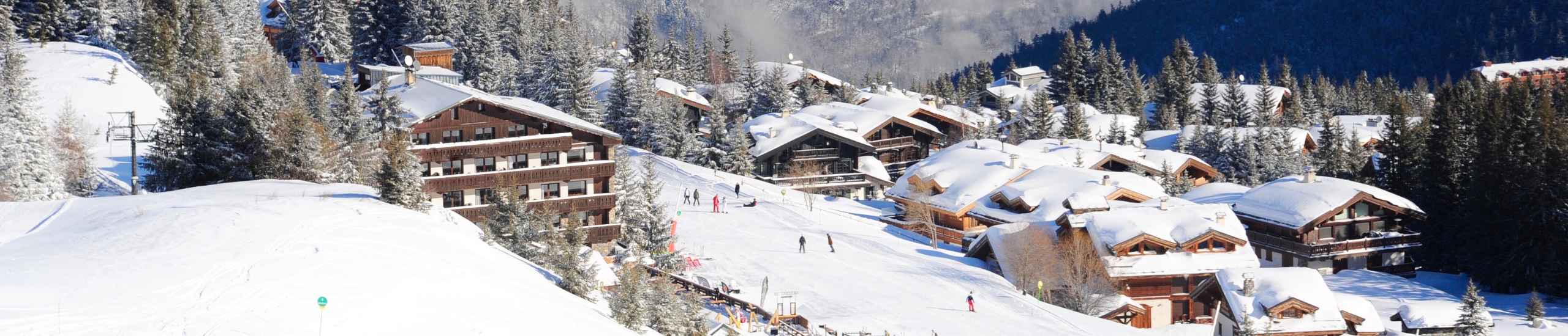 Ski resorts covered in snow with people skiing